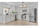 Bright kitchen featuring stainless appliances, white cabinets, and stylish lighting at 2313 N 87Th Way, Scottsdale, AZ 85257