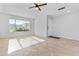 Bright living room with a ceiling fan, tile flooring and large windows at 2313 N 87Th Way, Scottsdale, AZ 85257