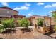 Backyard featuring a garden, fruit trees, and a shaded pergola, perfect for outdoor relaxation at 242 N Crosscreek Dr, Chandler, AZ 85225