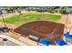 Aerial view of a baseball field with well maintained dirt, and grass, along with shaded seating at 242 N Crosscreek Dr, Chandler, AZ 85225