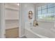 Bathroom featuring a modern soaking tub and walk in closet at 242 N Crosscreek Dr, Chandler, AZ 85225