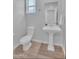 Well-lit bathroom featuring a pedestal sink and modern fixtures at 242 N Crosscreek Dr, Chandler, AZ 85225