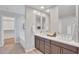 Bathroom featuring a dual sink vanity and a separate tub and shower at 242 N Crosscreek Dr, Chandler, AZ 85225