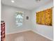 Bright, airy room featuring wood floors, white walls, and a large window for natural light at 242 N Crosscreek Dr, Chandler, AZ 85225