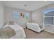 Light and airy bedroom furnished with two twin beds and neutral decor at 242 N Crosscreek Dr, Chandler, AZ 85225