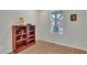 Cozy bedroom with wood floors, white walls, and a bright window at 242 N Crosscreek Dr, Chandler, AZ 85225
