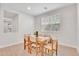 Well-lit dining room featuring a wooden table with seating for six and a large window at 242 N Crosscreek Dr, Chandler, AZ 85225