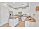 Bright kitchen featuring white cabinets, stainless steel appliances, and wood flooring at 242 N Crosscreek Dr, Chandler, AZ 85225