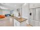 Open concept kitchen with island, stainless steel appliances, and view to the living room and stairs at 242 N Crosscreek Dr, Chandler, AZ 85225