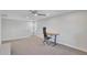 Bright, carpeted loft space with modern ceiling fan and an adjustable height desk at 242 N Crosscreek Dr, Chandler, AZ 85225