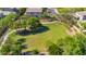 Aerial view of a neighborhood park with lush green grass, trees, playground, and walking path at 242 N Crosscreek Dr, Chandler, AZ 85225