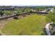 Aerial view of a community park with lush green grass and desert trees in a neighborhood setting at 242 N Crosscreek Dr, Chandler, AZ 85225