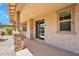 Covered patio featuring stone columns, backyard access, and a smooth concrete finish at 242 N Crosscreek Dr, Chandler, AZ 85225