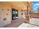 Covered patio with desert wall art, smooth concrete, and backyard access at 242 N Crosscreek Dr, Chandler, AZ 85225