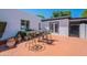 Paver patio with seating area, and white stucco walls in the backyard at 317 E Orange Dr, Phoenix, AZ 85012