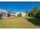 Large backyard with green grass, a shed, and mature landscaping at 317 E Orange Dr, Phoenix, AZ 85012
