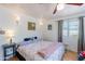 Bright bedroom featuring a ceiling fan, natural light, and a comfortable bed at 317 E Orange Dr, Phoenix, AZ 85012