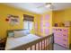 Vibrant bedroom with brightly colored walls, modern bed frame, and built in storage at 317 E Orange Dr, Phoenix, AZ 85012