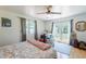Airy bedroom boasts backyard access, a ceiling fan and neutral walls at 317 E Orange Dr, Phoenix, AZ 85012
