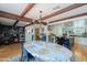 Bright dining room featuring wood beams, a chandelier, built-in shelving, and an open kitchen with island seating at 317 E Orange Dr, Phoenix, AZ 85012