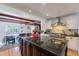 Gourmet kitchen with granite countertops, modern appliances, and open access to a dining area at 317 E Orange Dr, Phoenix, AZ 85012