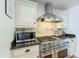 Close up of the kitchen featuring stainless steel stove, tile backsplash, and custom cabinetry at 317 E Orange Dr, Phoenix, AZ 85012