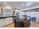 Bright and airy kitchen with a large center island, stainless steel appliances, and a seamless flow to the dining area at 317 E Orange Dr, Phoenix, AZ 85012