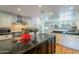 Modern kitchen features granite countertops, stainless steel appliances, and custom cabinetry at 317 E Orange Dr, Phoenix, AZ 85012