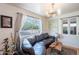 Cozy living room featuring a stylish sofa, hardwood floors, and windows offering a neighborhood view at 317 E Orange Dr, Phoenix, AZ 85012
