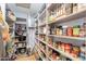 Organized walk-in pantry with shelving for ample storage of groceries and kitchen essentials at 317 E Orange Dr, Phoenix, AZ 85012