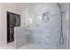 Updated bathroom with sleek glass shower, modern fixtures, and tiled walls at 317 E Orange Dr, Phoenix, AZ 85012