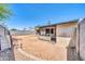 Backyard view of covered patio area with desert landscaping and cinder block fence at 3201 W Mohawk Ln, Phoenix, AZ 85027