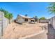 A sunny backyard with a covered patio, cinder block fencing, and desert landscaping at 3201 W Mohawk Ln, Phoenix, AZ 85027