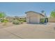 A suburban home showcasing a spacious driveway and well-maintained desert landscaping at 3201 W Mohawk Ln, Phoenix, AZ 85027