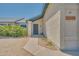 Close-up of a home's entry featuring a secure wrought iron door and manicured flowerbeds at 3201 W Mohawk Ln, Phoenix, AZ 85027
