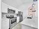 Updated kitchen with stainless steel appliances, white cabinets, and stylish geometric backsplash tiles at 3201 W Mohawk Ln, Phoenix, AZ 85027