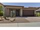 Charming home featuring desert landscaping, a brick driveway, and a covered front porch at 3411 E Louise Dr, Phoenix, AZ 85050