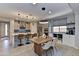 Open kitchen and dining area featuring modern lighting and sleek countertops at 3411 E Louise Dr, Phoenix, AZ 85050