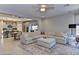 Open-concept living room with a large sectional sofa and an adjacent kitchen at 3411 E Louise Dr, Phoenix, AZ 85050