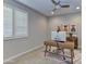 Bright office space with plantation shutters, wood desk, and accent decor at 3411 E Louise Dr, Phoenix, AZ 85050