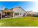 Expansive backyard featuring a covered patio, green lawn, and well-maintained landscaping, perfect for outdoor living at 3412 E Kristal Way, Phoenix, AZ 85050