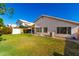 Well-maintained backyard with a patio, lush lawn, and privacy fencing, ideal for entertaining and relaxation at 3412 E Kristal Way, Phoenix, AZ 85050