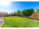 Spacious backyard with healthy lawn and mature trees, providing a serene outdoor space at 3412 E Kristal Way, Phoenix, AZ 85050