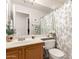 Well-lit bathroom with a vanity, toilet, and a shower/tub combo with a decorative shower curtain at 3412 E Kristal Way, Phoenix, AZ 85050