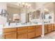Spacious bathroom featuring a double sink vanity, large mirror, and views into the main bedroom at 3412 E Kristal Way, Phoenix, AZ 85050