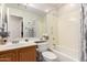 Bright bathroom featuring a bathtub, integrated sink, a functional toilet, and a well-lit mirror at 3412 E Kristal Way, Phoenix, AZ 85050