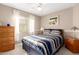 Welcoming bedroom with warm tones, a ceiling fan, and a window dressed with sheer curtains at 3412 E Kristal Way, Phoenix, AZ 85050