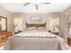 Cozy bedroom featuring a wooden bed frame, neutral tones, and natural light streaming through the window at 3412 E Kristal Way, Phoenix, AZ 85050