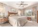 Comfortable bedroom with a ceiling fan, wood furniture, and a view of the outdoor space at 3412 E Kristal Way, Phoenix, AZ 85050