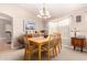 Inviting dining room features a wood table, comfortable chairs, and a chandelier for elegant dining at 3412 E Kristal Way, Phoenix, AZ 85050